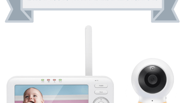 white video baby monitor screen with white and yellow circular camera with stand