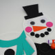 Create buttons by cutting two circles from black glitter cardstock. Glue to the middle of the second paper plate below the scarf.