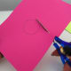 Cut two small circles from the pink cardstock to create the cheeks. Glue the pink cheeks on the paper plate, one on each side.