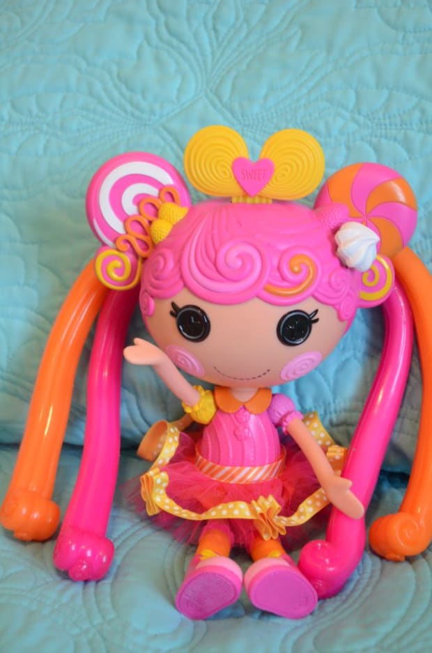 doll with button eyes and pink hair
