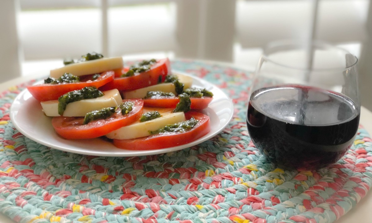 caprese salad and glass of wine