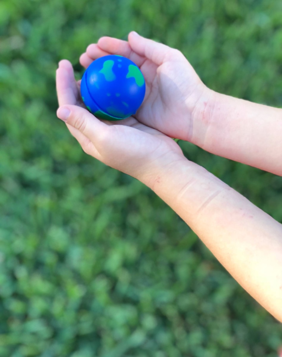 child holding the Earth in her hands