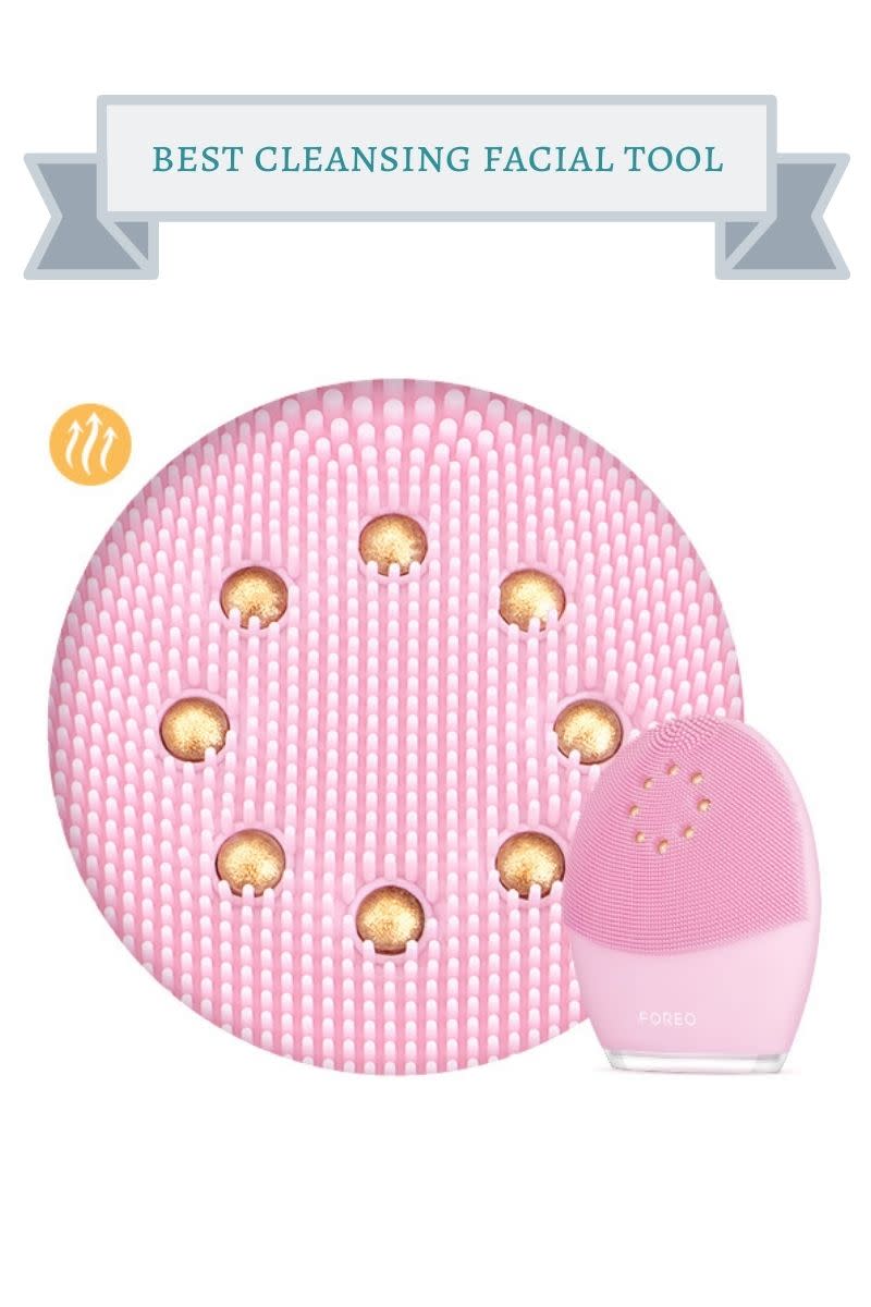light pink foreo cleansing tool with gold beads in a circle on the top