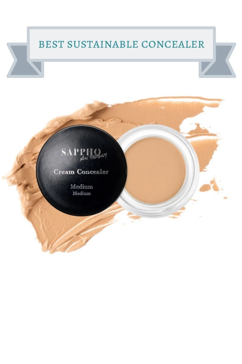 black jar of sappho cream concealer on top of peach colored swatch of product