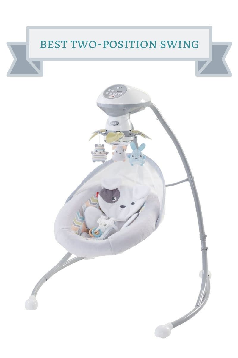 white and gray fisher price baby swing with gray and white puppy cushion in shite and multi-color striipe, white and blue puppy mobile above