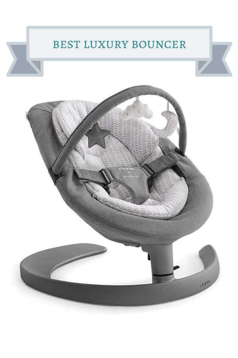 gray and white nuna bouncer with star, cloud and moon toys attached to toy bar