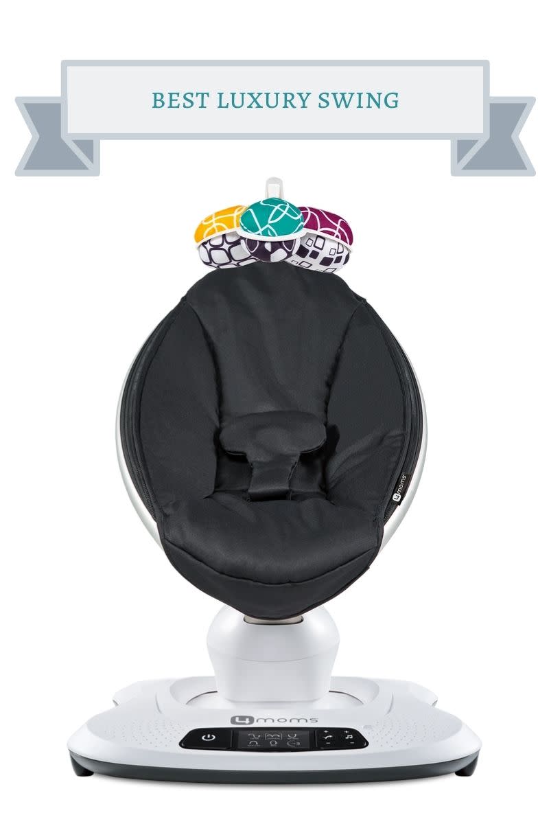black mamaroo oval shaped baby swing with teal, yellow, purple and black and white print balls mobile on top