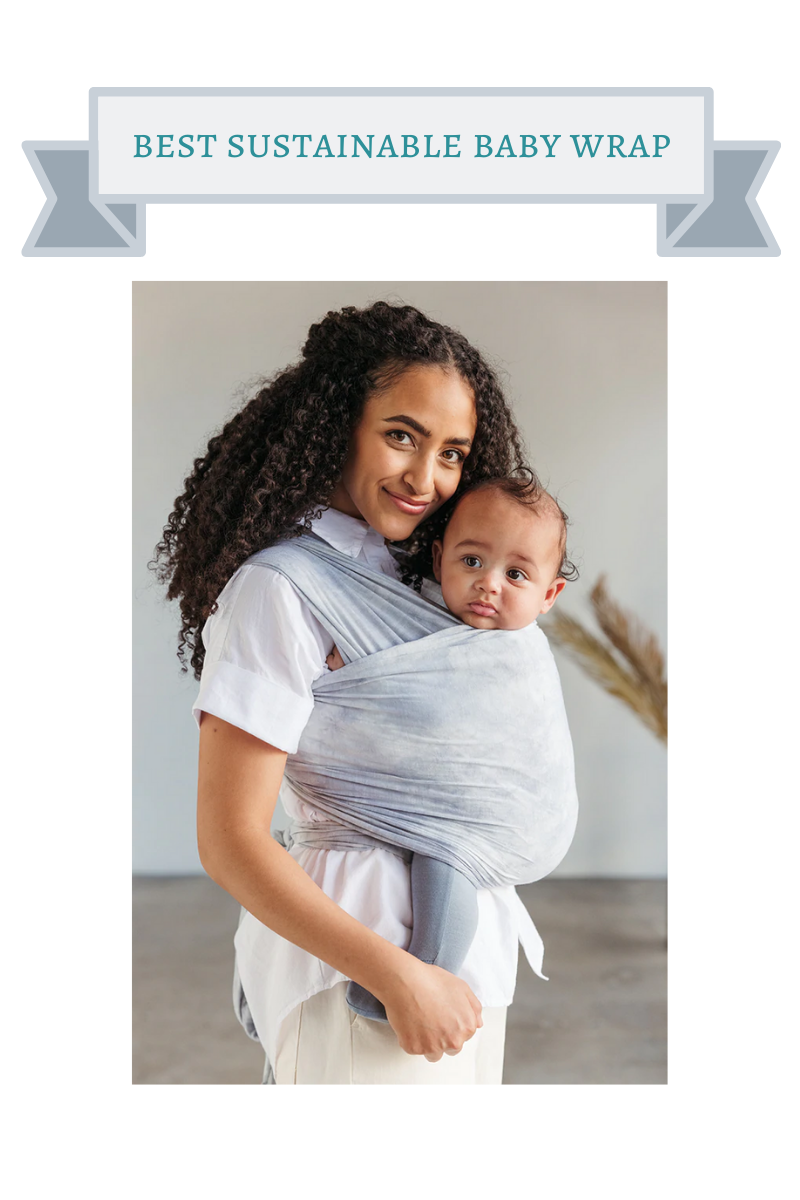 woman with long brown natural curls wearing baby in cloud blue baby wrap