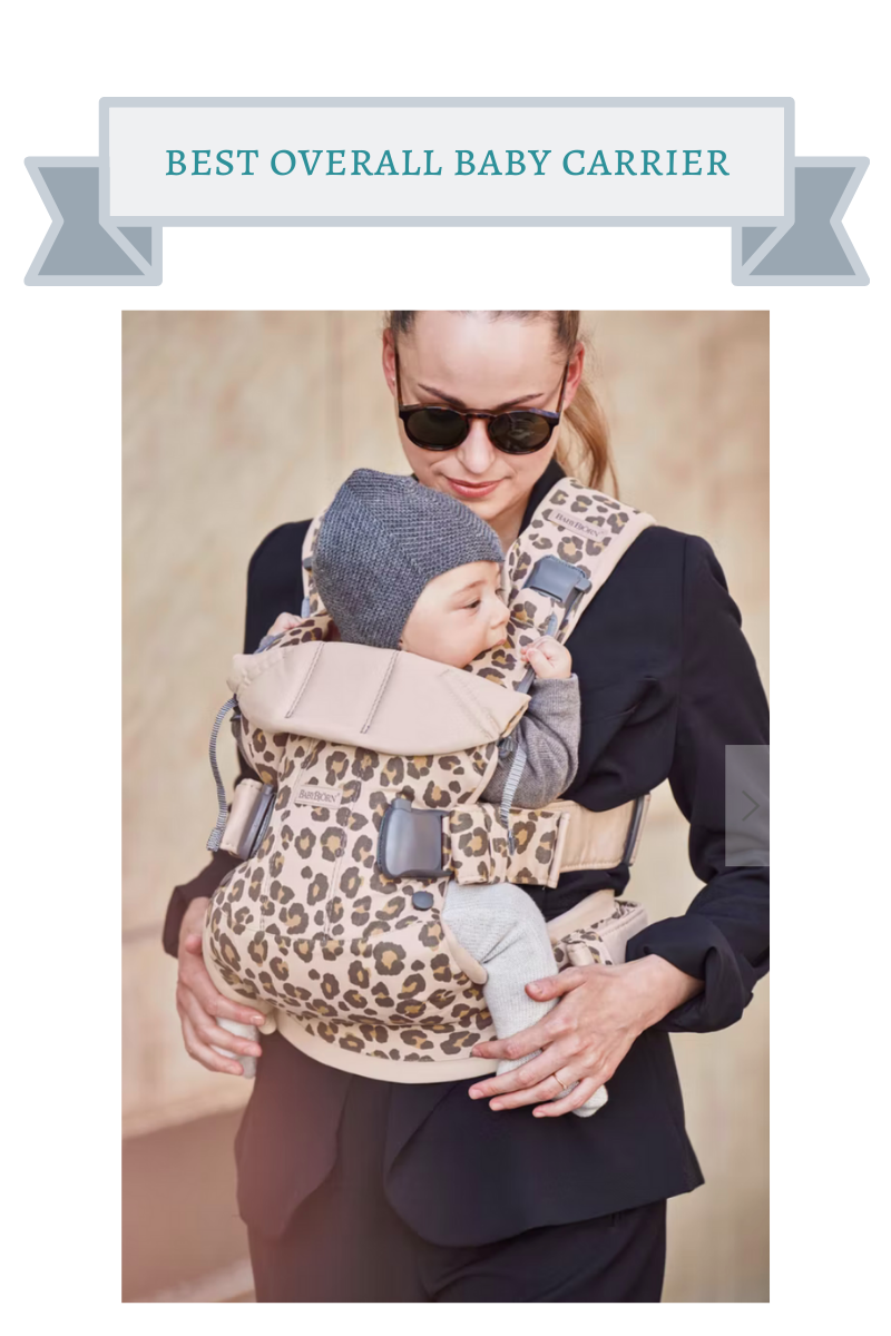 woman in black sunglasses wearing a baby in a leopard print baby bjorn carrier