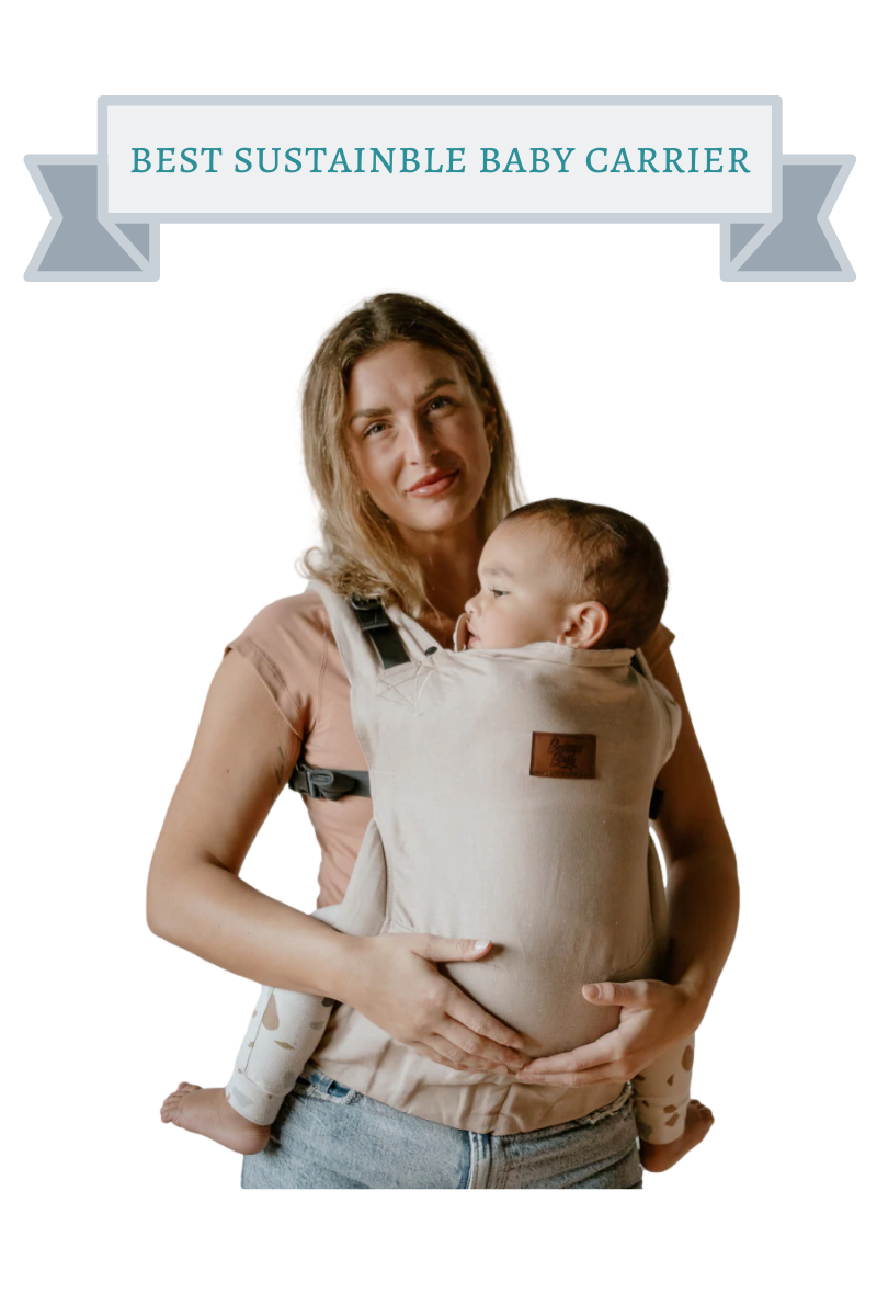 blond woman holding baby in beige baby carrier