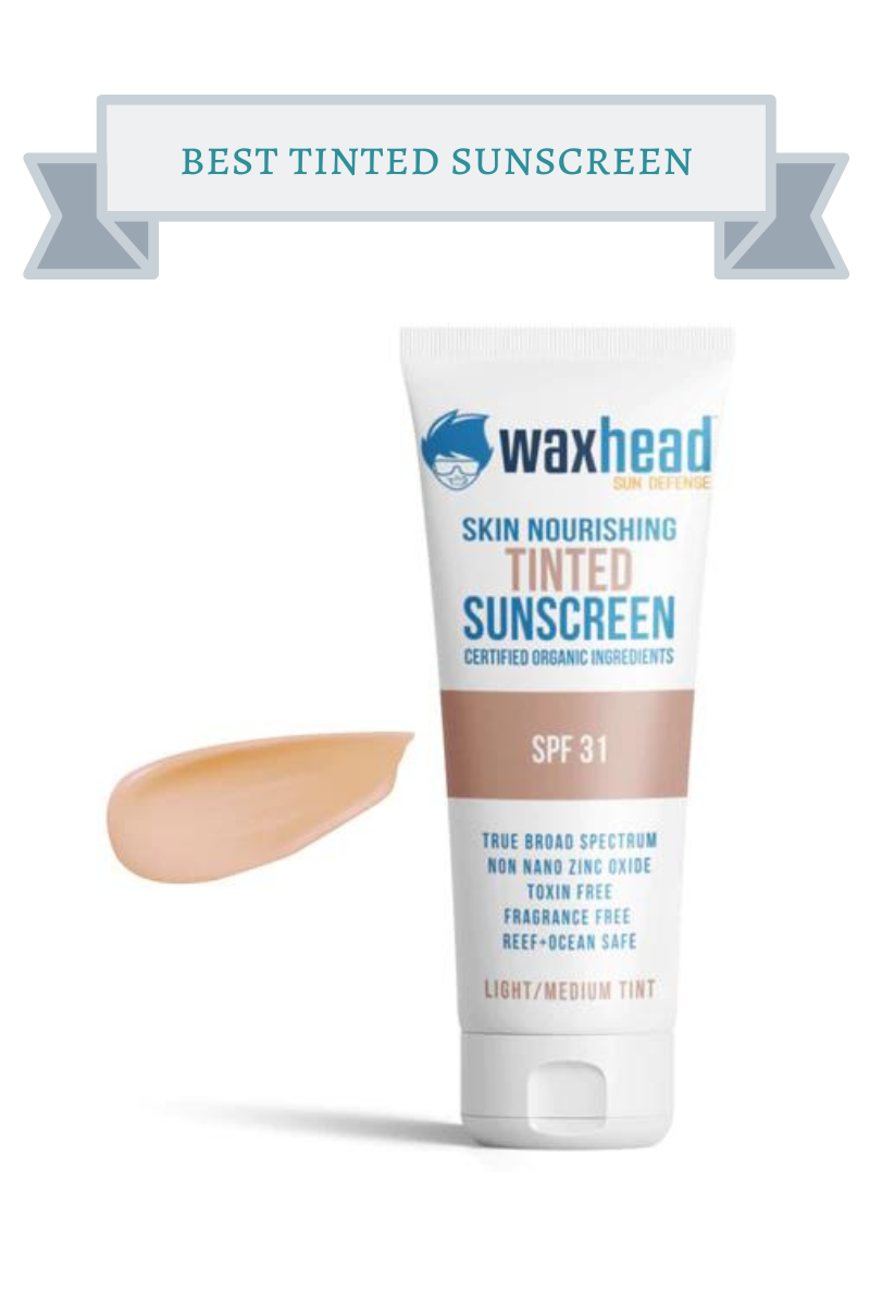bottle of waxhead tinted sunscreen with blue writing and drawing of guy with spiked up hai and sunglasses on it