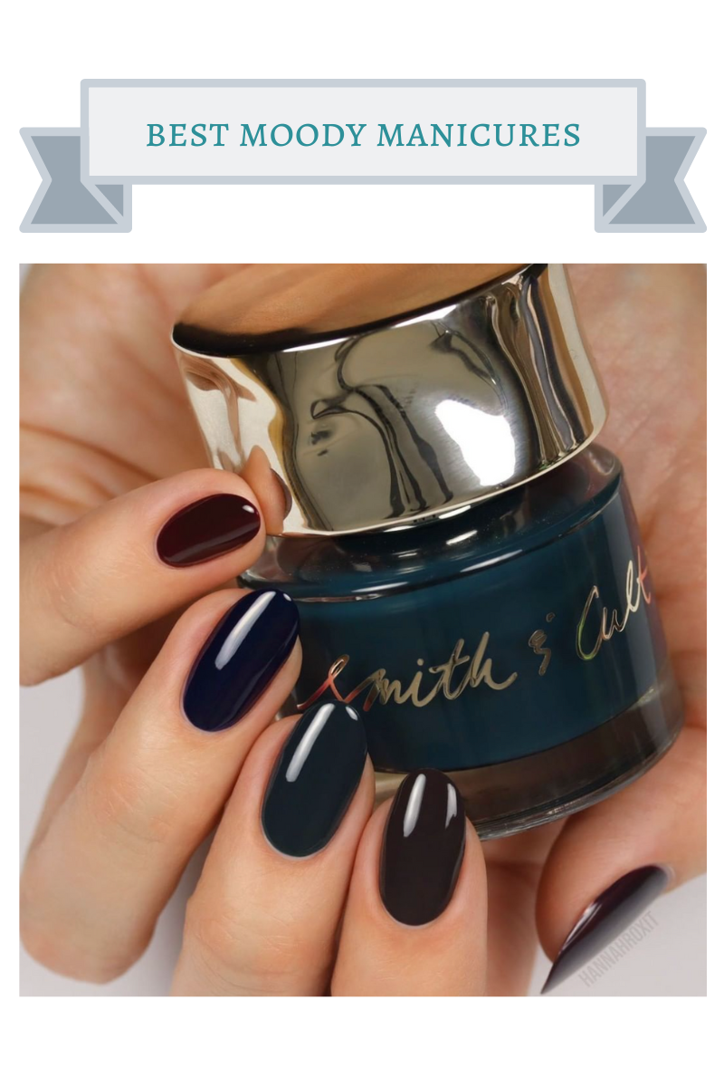 smith & cult burgundy, navy, dark green, plum and espresso colored painted nails on hand holding dark green nail polish bottle